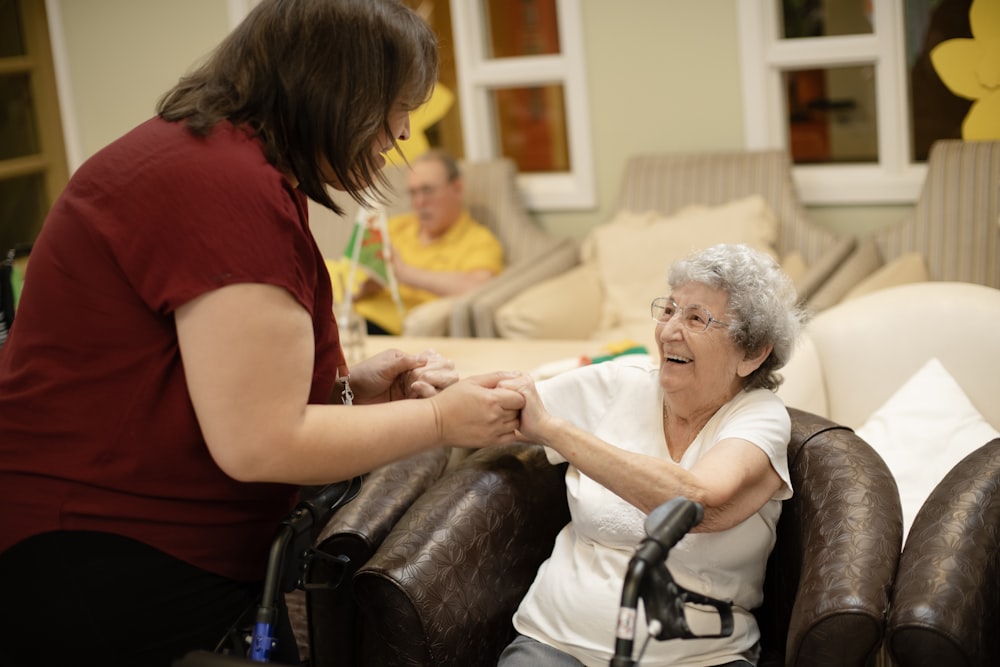 Caregiver holding hand of senior woman